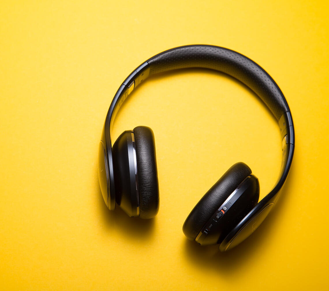 Black headphones on a yellow background